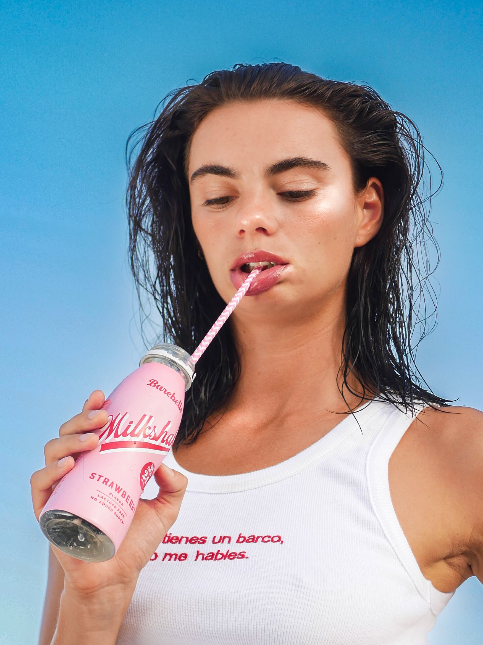Anne Charlotte, close portrait — eyes down, sipping a milkshake through a straw